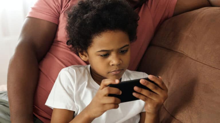 Kid Playing Game on Smartphone